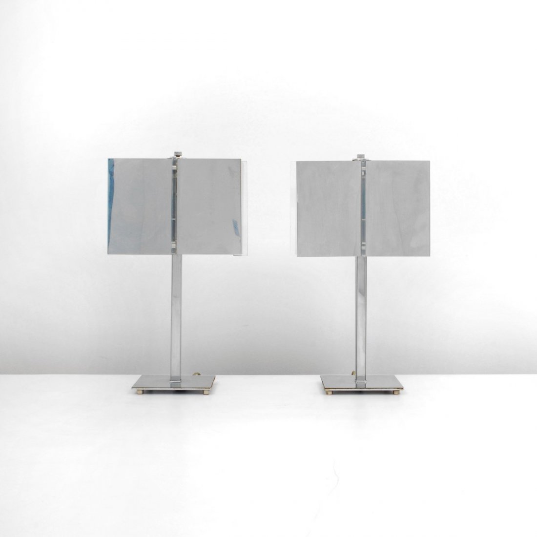 Pair of Charles Hollis Jones Lamps: Designer & Manufacturer: Charles Hollis Jones Markings: none Country of Origin & Materials: USA; chrome, acrylic Additional Information & Circa: Pair of chrome table lamps with acrylic detailing by Ch