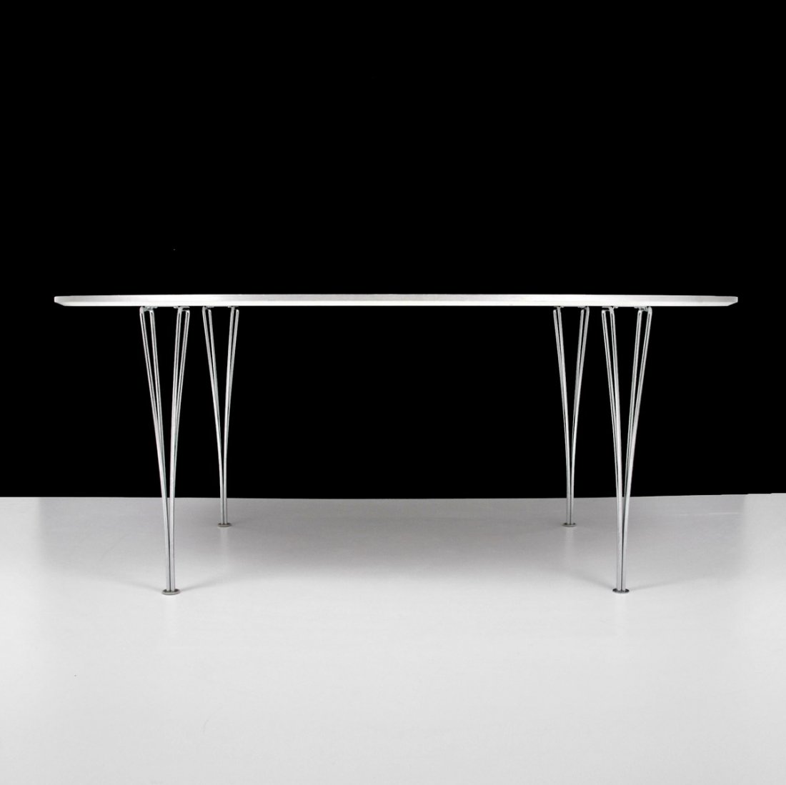 Mathsson/Hein "Super-Ellipse" Dining Table: Designer & Manufacturer: Bruno Mathsson/Piet Hein; Fritz Hansen Markings: marked; dated Country of Origin & Materials: Denmark; chrome, laminate Additional Information & Circa: "Super-Ellipse" dining