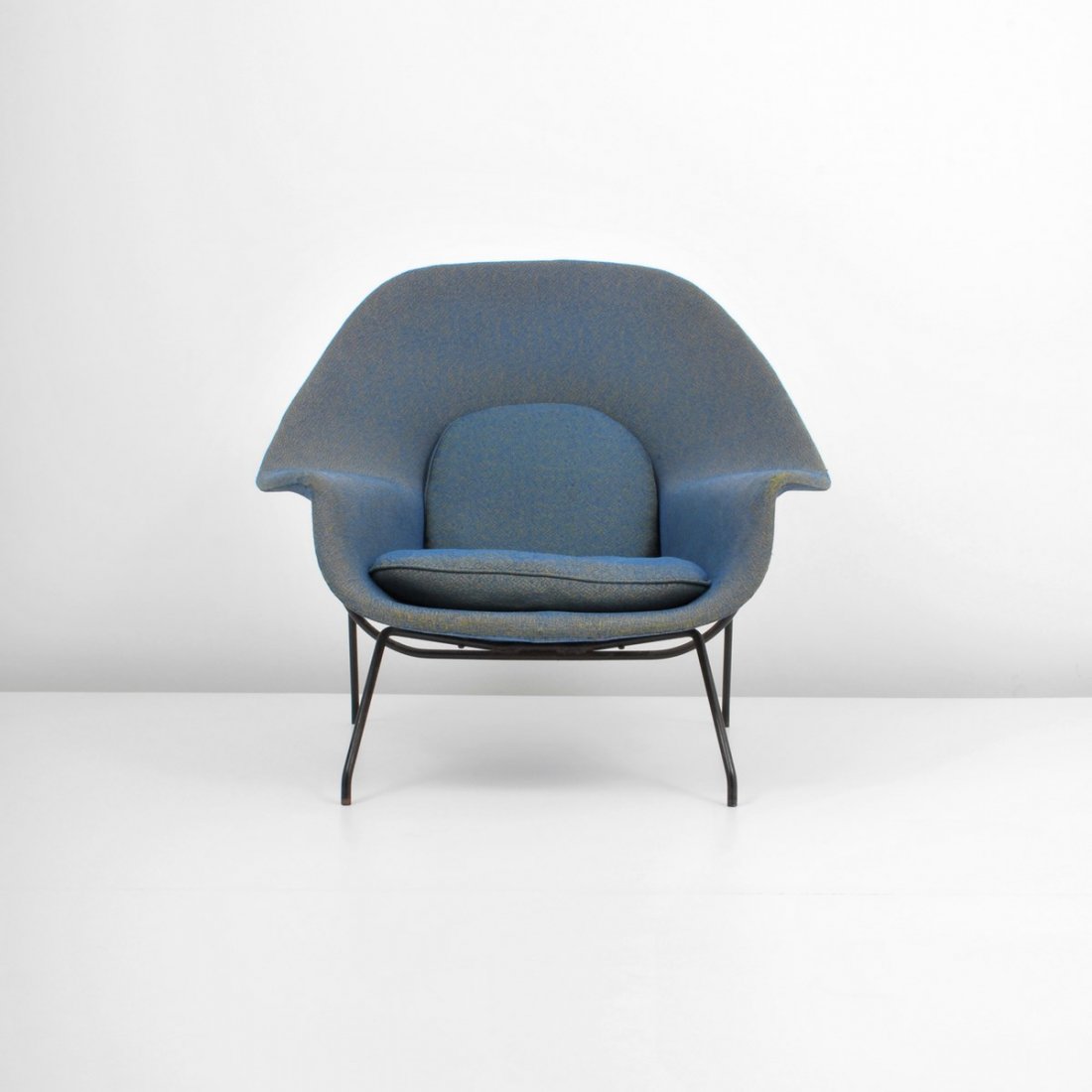 Early Eero Saarinen "Womb" Lounge Chair: Designer & Manufacturer: Eero Saarinen; Knoll Associates Markings: marked Country of Origin & Materials: USA; iron, upholstery Additional Information & Circa: Early "Womb" lounge chair by Eero Saarine