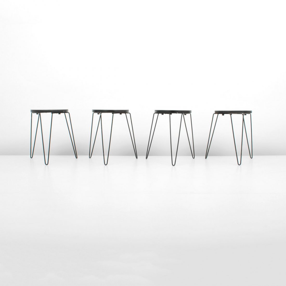 Florence Knoll Stacking Stools, Set of 4: Designer & Manufacturer: Florence Knoll; Knoll Associates Inc. Markings: marked Country of Origin & Materials: USA; wood, iron Additional Information & Circa: Set of four early stacking stools by Flor