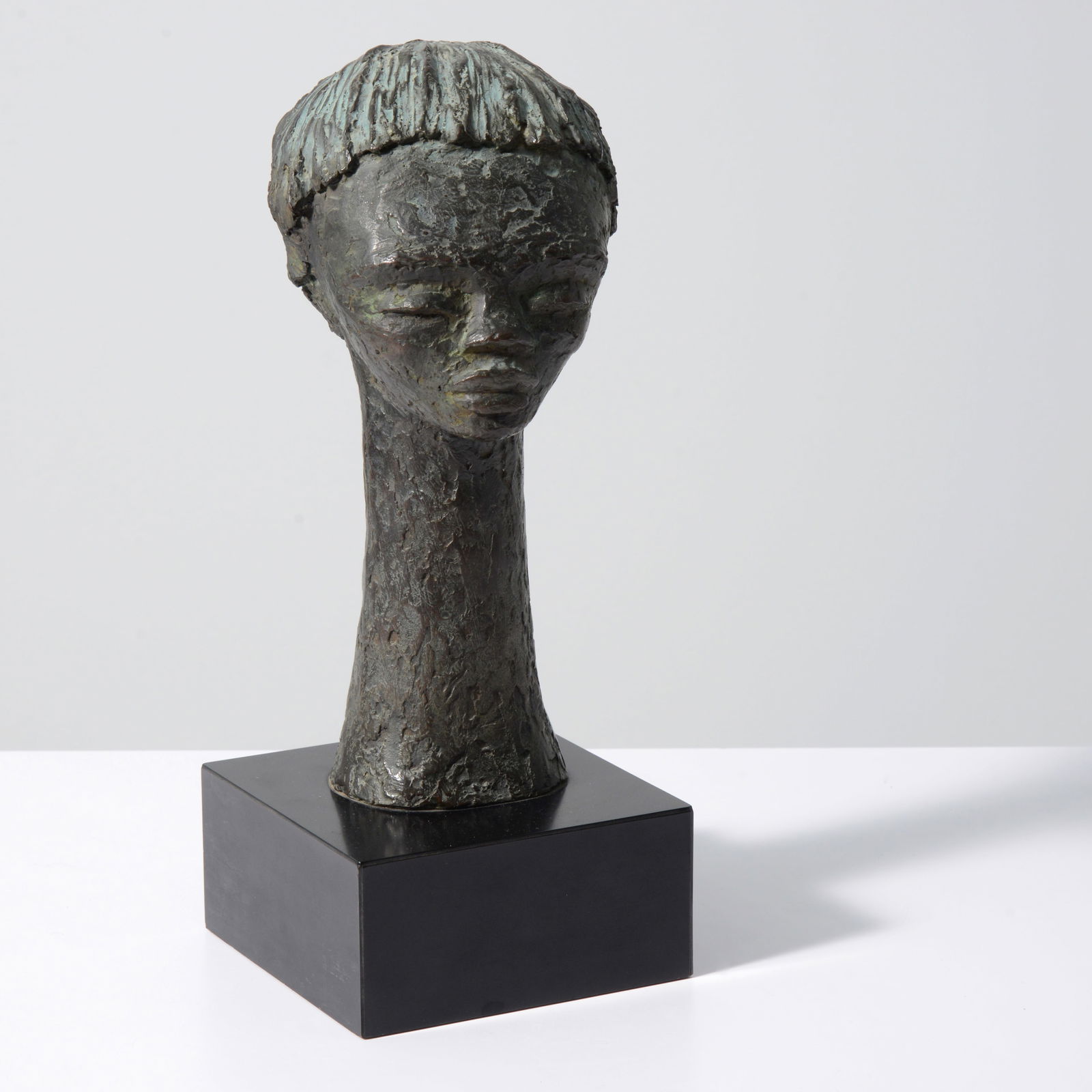 Angel Botello CABEZA DE NINA Sculpture: Artist/Designer; Manufacturer: Angel Botello (Spanish/ Puerto Rican American, 1913-1986)Marking(s); notes: signed, ed. 8/9Materials: bronze, laminated wood baseDimensions