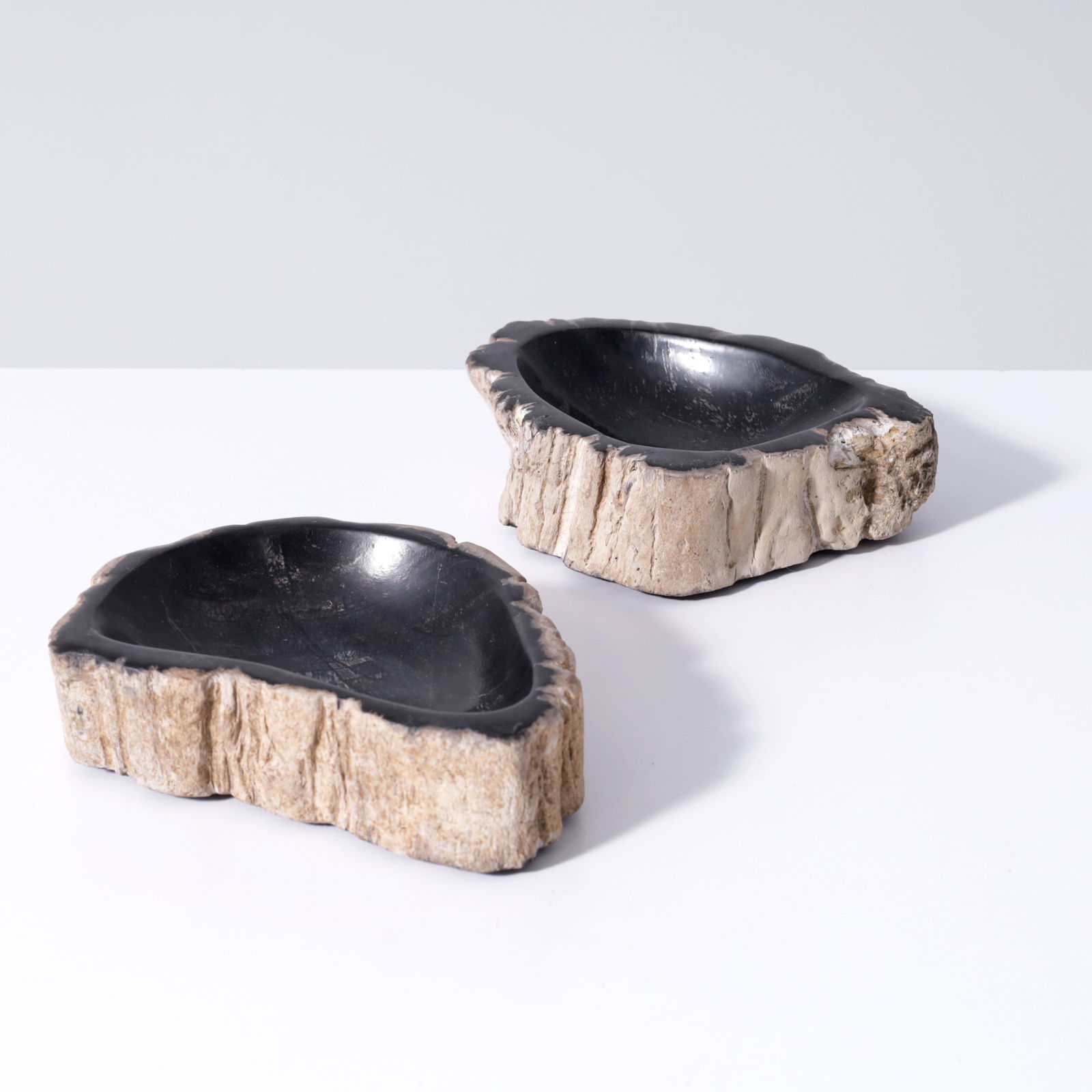 2 Petrified Wood Ashtrays / Bowls: Artist/Designer; Manufacturer: unknownMarking(s); notes: marking(s)Materials: petrified woodDimensions (H, W, D): 1.75"h, 6.5"w, 5&