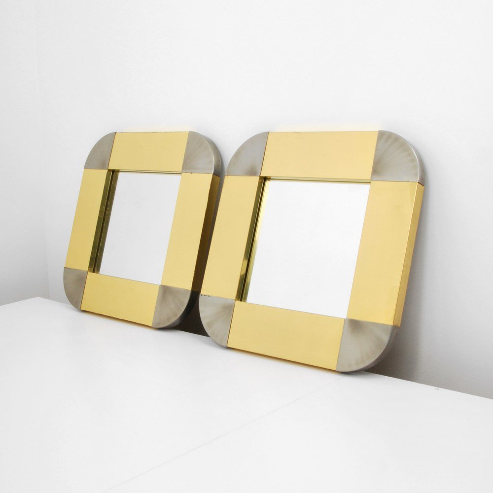 Pair of Curtis Jere Mirrors: Designer & Manufacturer: Curtis Jere; Artisan House Markings: marked; dated Country of Origin & Materials: USA; chrome, brass Additional Information & Circa: Pair of chrome and brass mirrors by Curtis
