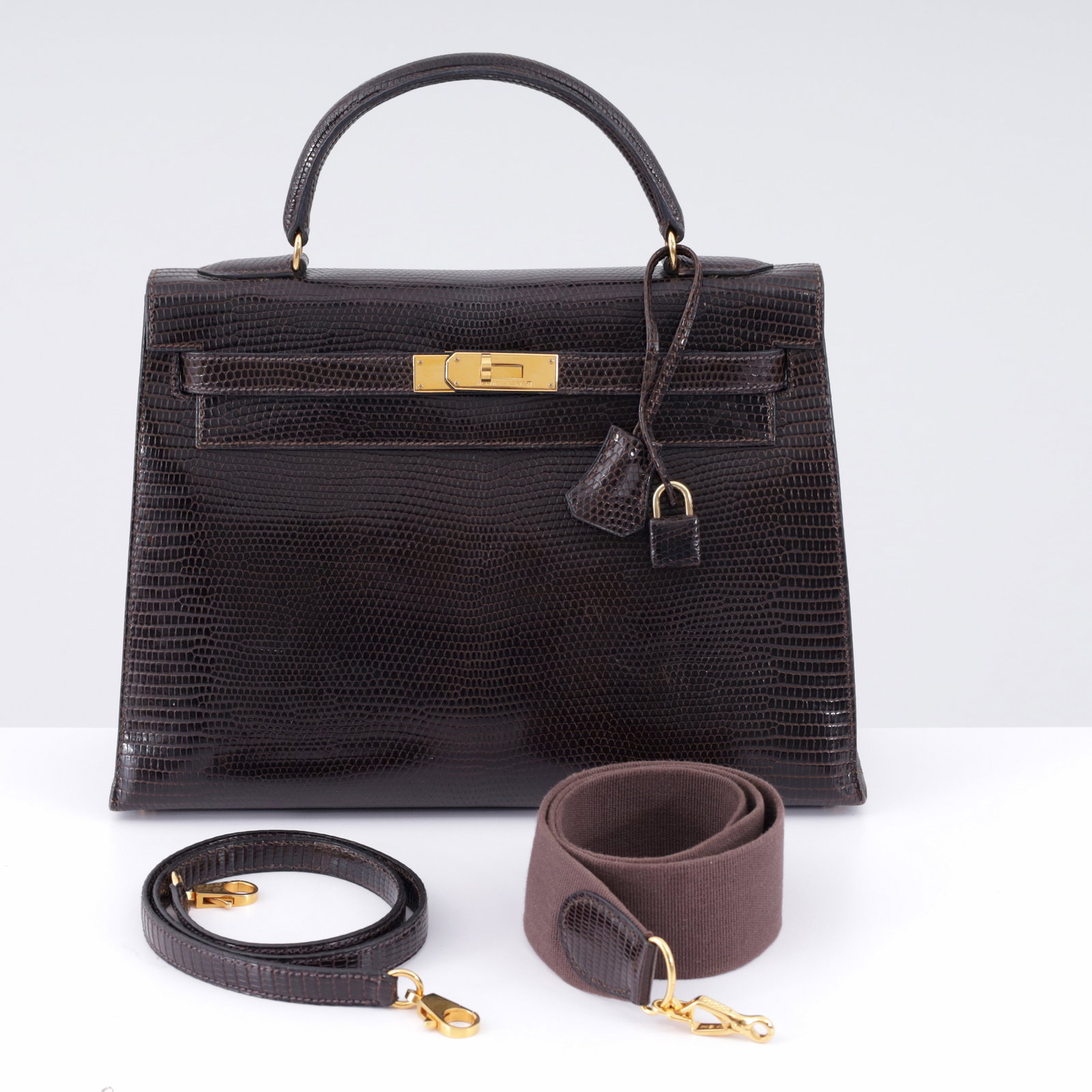Hermes KELLY 32 Espresso Brown Niloticus Lizard Handbag: Artist/Designer/Manufacturer: Hermes (France) Marking(s); notes: Hermes imprints, blind stamp, (Z), marking(s); 1996 Materials: Varanus niloticus lizard, leather, gold-tone metal ha