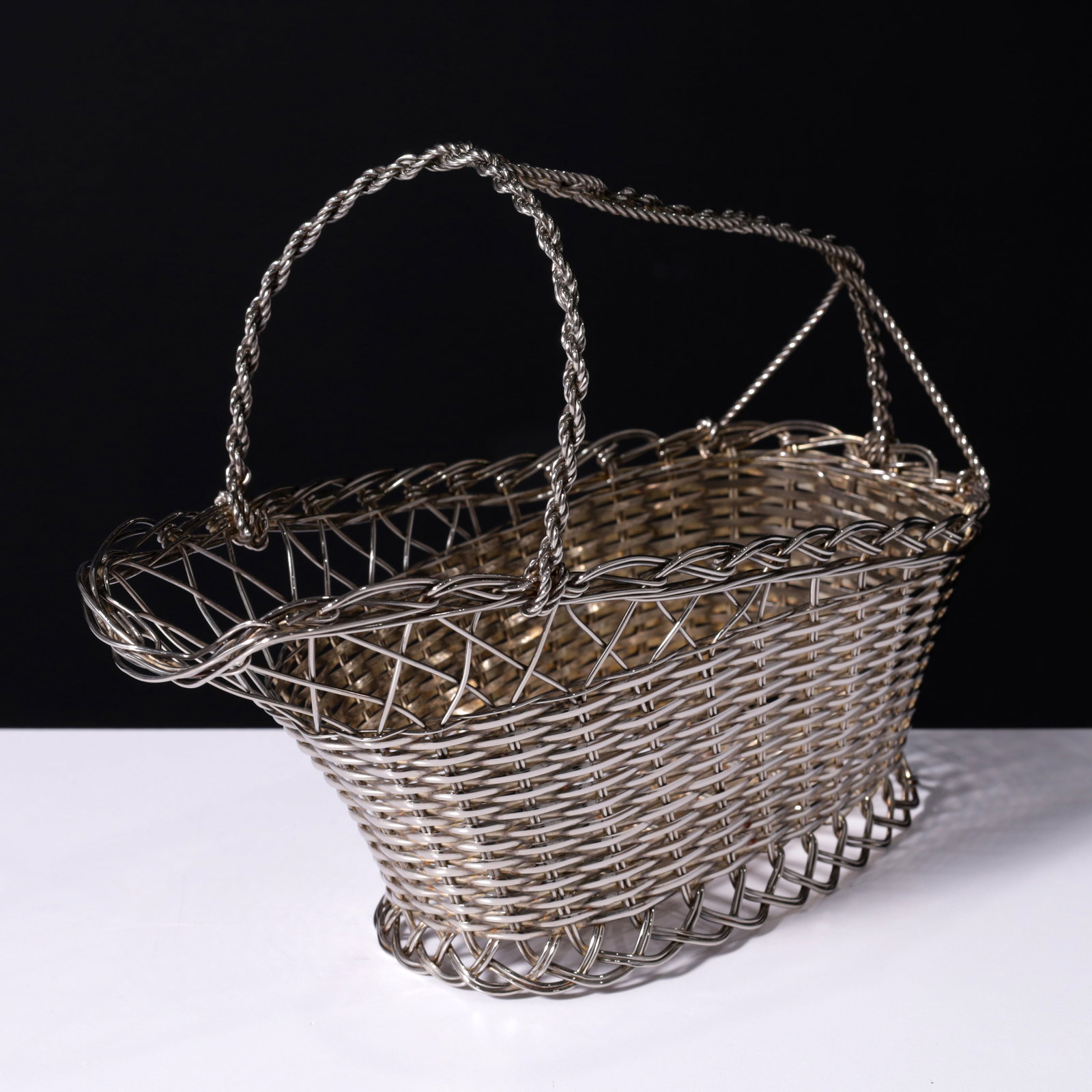 Wine Bottle Basket: Artist/Designer/Manufacturer: unknown (China) Marking(s); notes: label Materials: silver-tone metal wire Dimensions (H, W, D): 7.75"h, 10&q