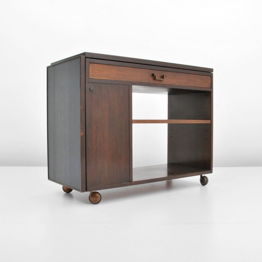 Edward Wormley Bar/Serving Cart: Designer & Manufacturer: Edward Wormley; Dunbar Markings: marked Country of Origin & Materials: USA; wood, faux slate, metal Additional Information & Circa: Wheeled serving cart/bar with flip top exte
