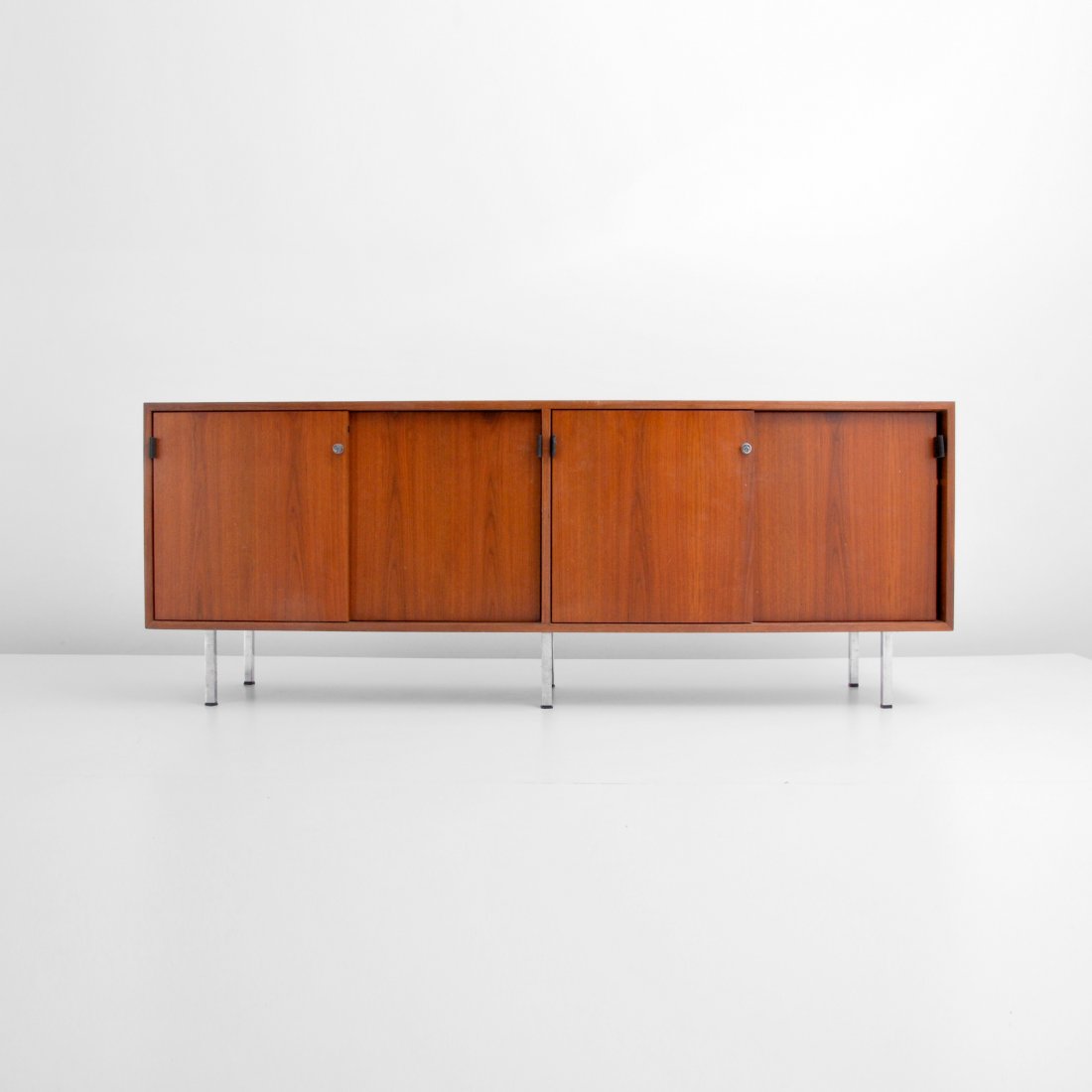 Florence Knoll Cabinet: Designer & Manufacturer: Florence Knoll; Knoll Associates Markings: none Country of Origin & Materials: USA; walnut, chrome Additional Information & Circa: Cabinet/credenza with two pairs of doors, on