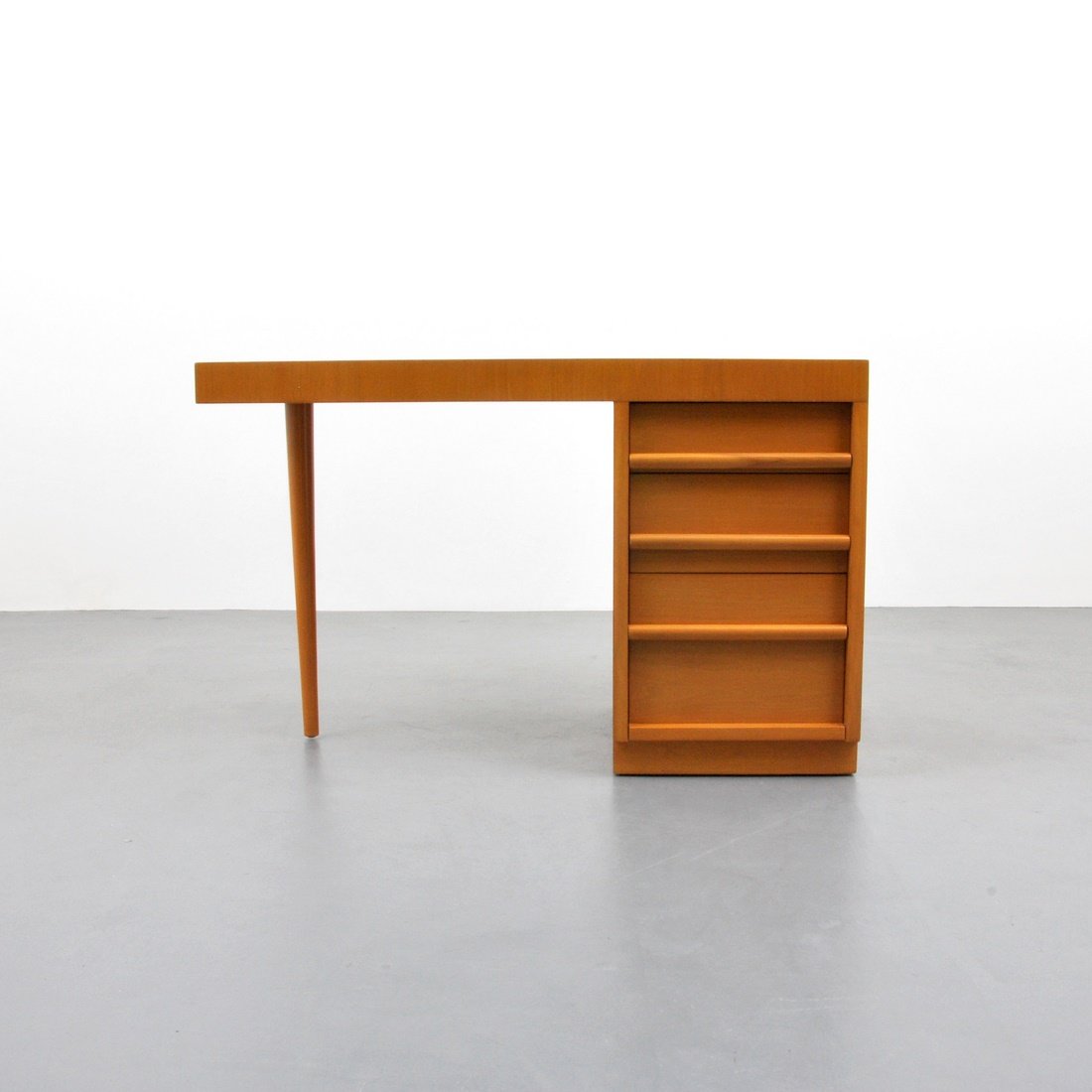 T.H. Robsjohn-Gibbings Desk: Designer & Manufacturer: T.H. Robsjohn-Gibbings; Widdicomb Markings: marked Country of Origin & Materials: USA; walnut Additional Information & Circa: Desk with three drawers and finished back, all dr
