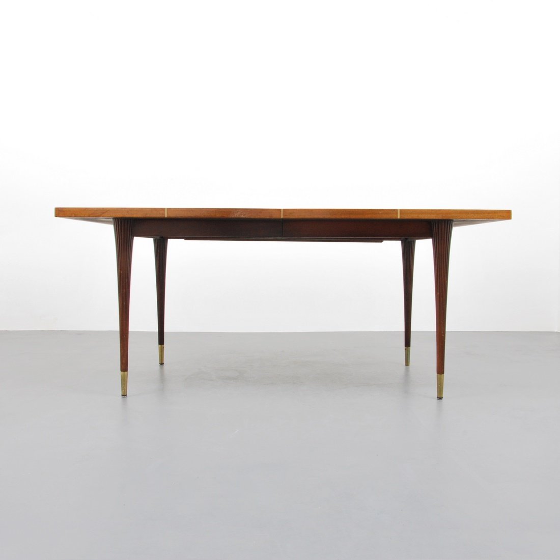Tommi Parzinger Dining Table, 2 Leaves: Designer & Manufacturer: Tommi Parzinger; Charak Modern Markings: marked Country of Origin & Materials: USA; flamed mahogany, brass Additional Information & Circa: Dining table with two 17" leaves in