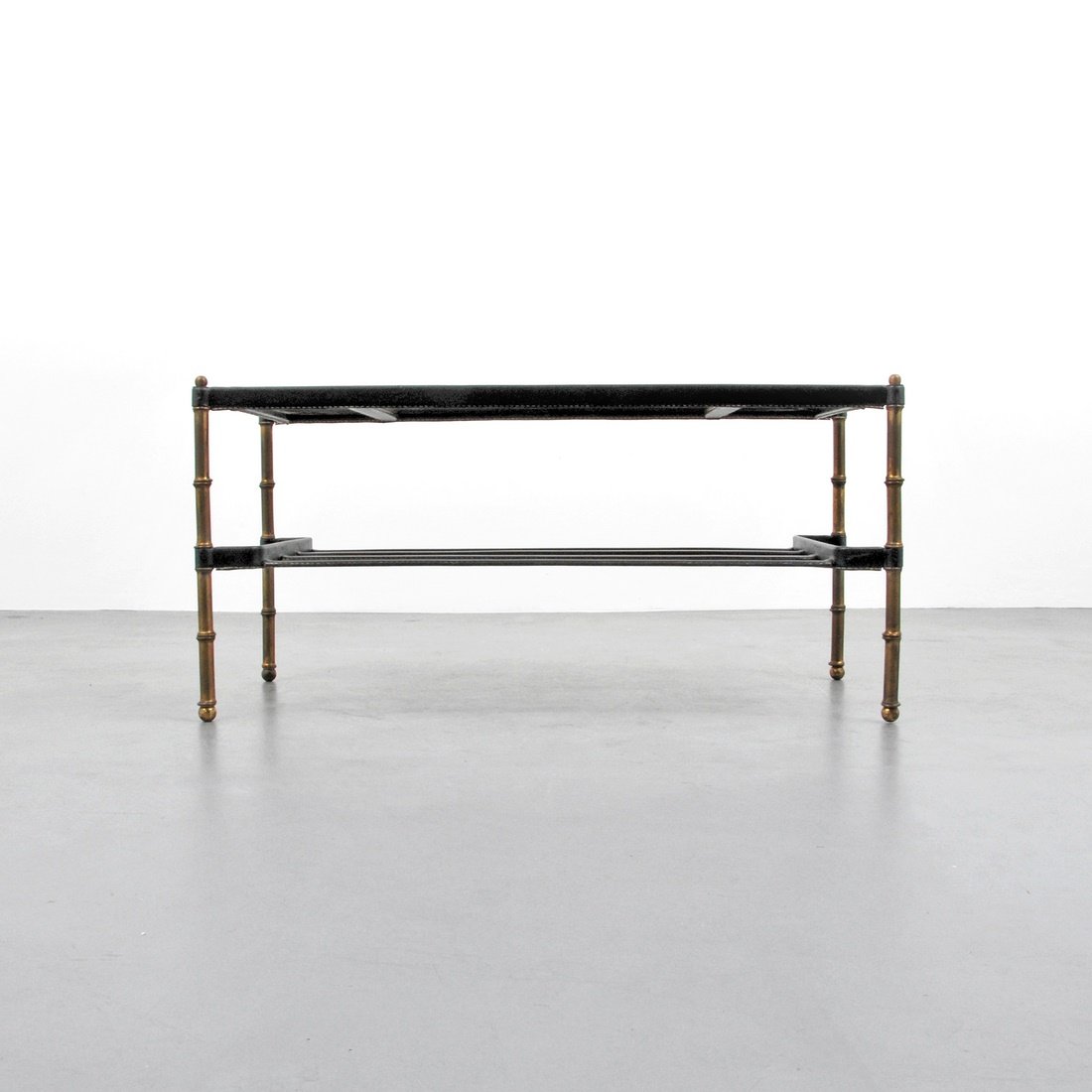 Jacques Adnet Coffee Table: Designer & Manufacturer: Jacques Adnet Markings: none Country of Origin & Materials: France; metal, leather, glass Additional Information & Circa: Leather wrapped coffee table with lower shelf by Jacq