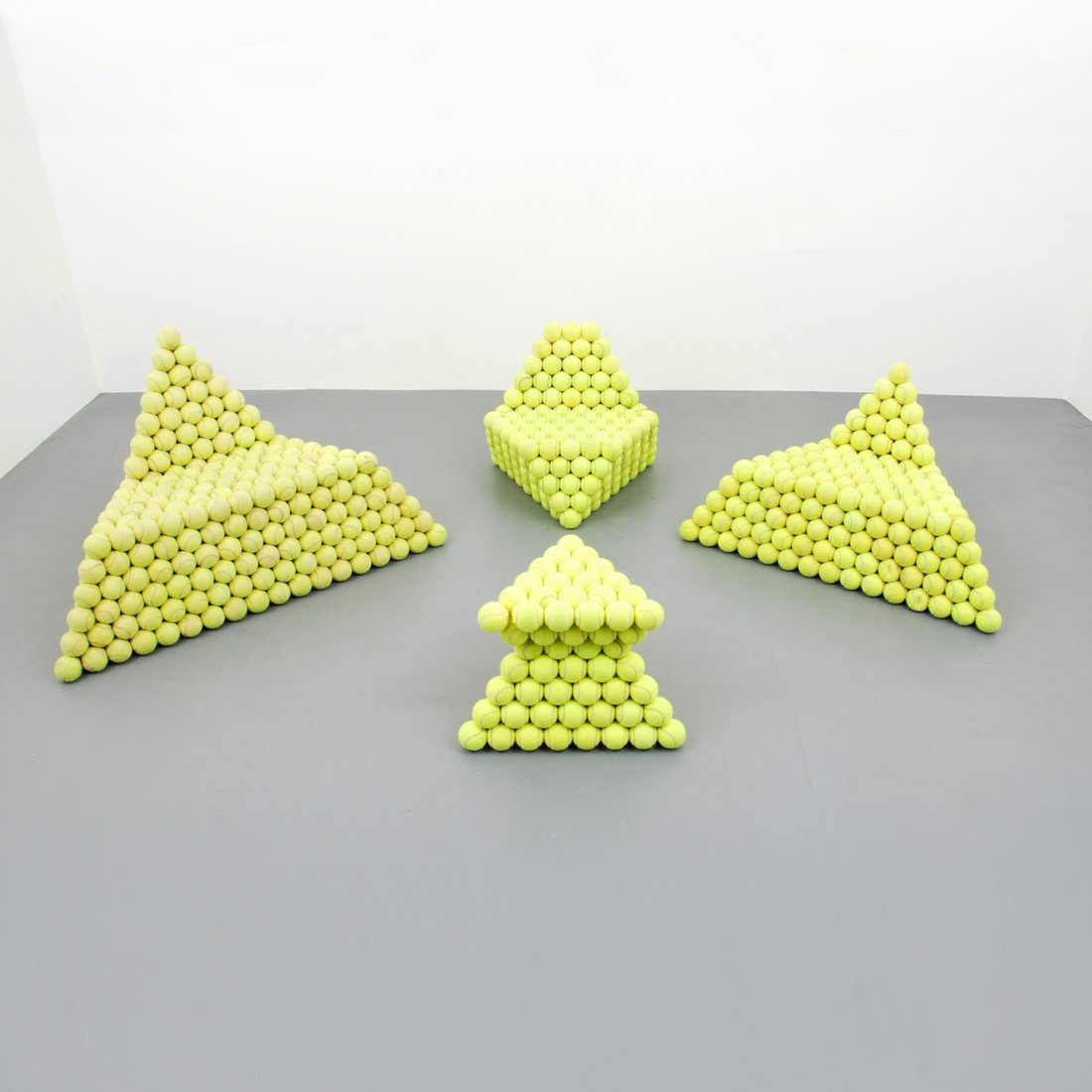 John Quirk 'Tennis Ball' Suite: Designer & Manufacturer: John Quirk Markings: none Country of Origin & Materials: USA; tennis balls, wood Additional Information & Circa: Suite 'Tennis Ball' comprised of three lounge chairs and a sid