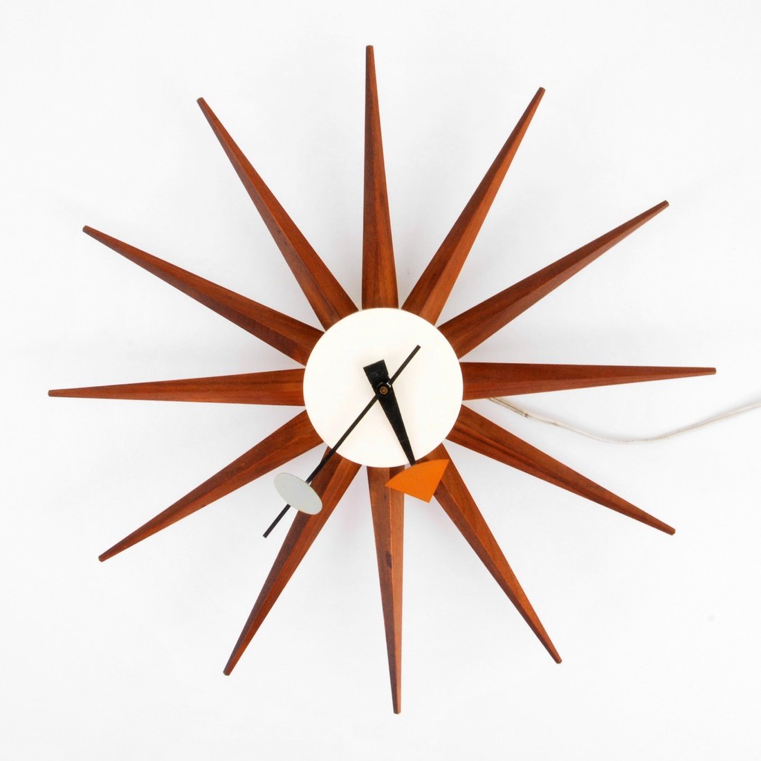 George Nelson 'Spike' Wall Clock: Designer & Manufacturer: George Nelson; Howard Miller Clock Co. Markings: marked Country of Origin & Materials: USA; wood, enameled metal Additional Information & Circa: Wall mounted 'Spike/Starburst'