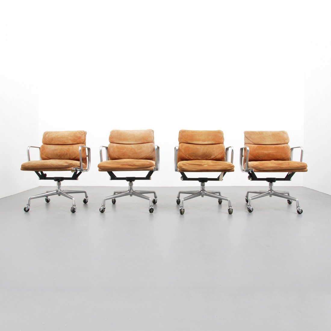 Charles & Ray Eames 'Soft Pad' Chairs: Designer & Manufacturer: Charles & Ray Eames; Herman Miller Markings: marked Country of Origin & Materials: USA; aluminum, suede Additional Information & Circa: Set of four suede 'Soft Pad' armed swiv