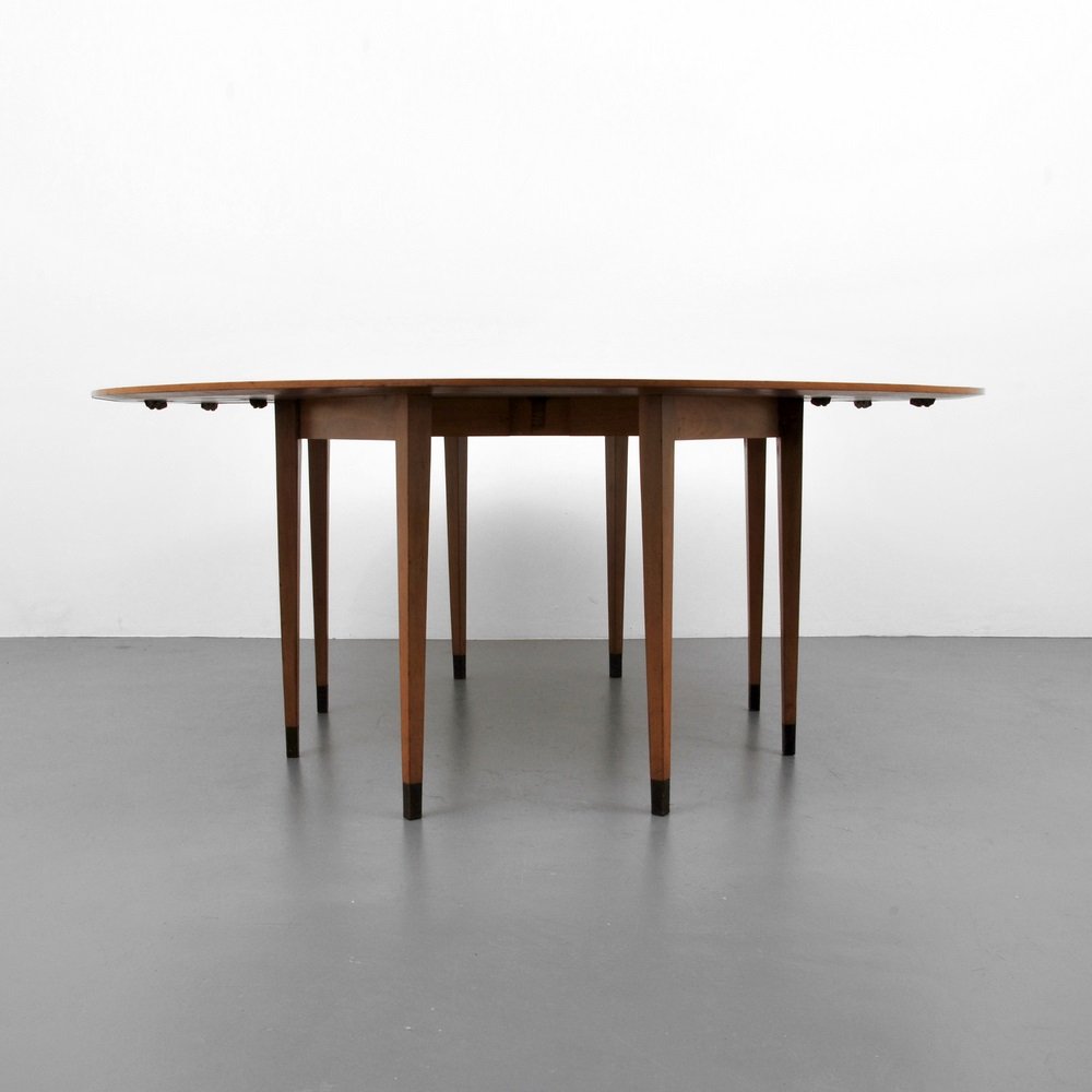 Edward Wormley Dining/Console Table: Designer & Manufacturer Edward Wormley; Dunbar Markings none Country of Origin & Materials USA; bleached walnut Additional Information & Circa Model 4913, drop-leaf dining/console table with brass s