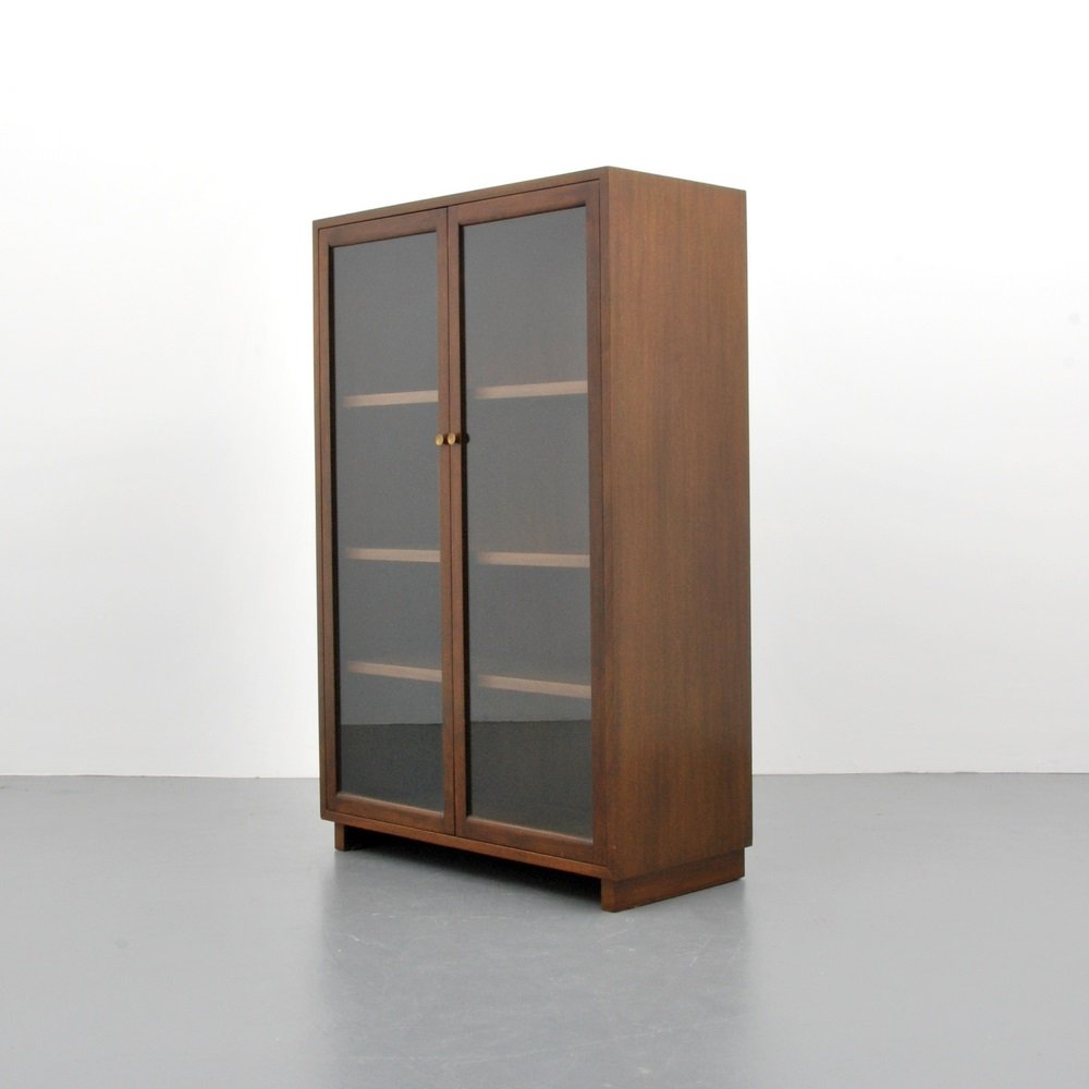Edward Wormley China Cabinet/Bookcase: Designer & Manufacturer Edward Wormley; Dunbar Markings none Country of Origin & Materials USA; mahogany, glass, metal Additional Information & Circa Two glass doors reveal three adjustable shelves.