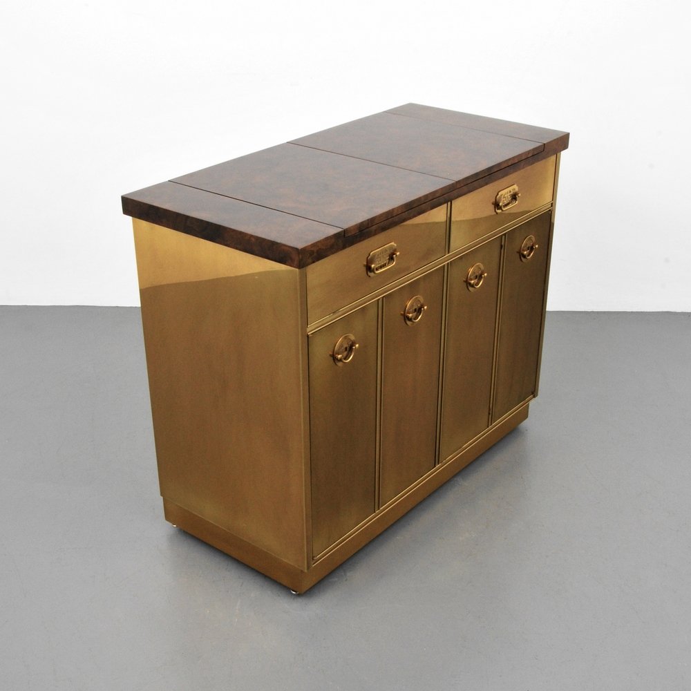 Mastercraft Bar/Server: Designer (Artist) & Manufacturer: Mastercraft Markings: marked Country of Origin & Materials: USA; brass, burl wood, laminate Additional Information: Wheeled bar with flip top serving area, two drawer