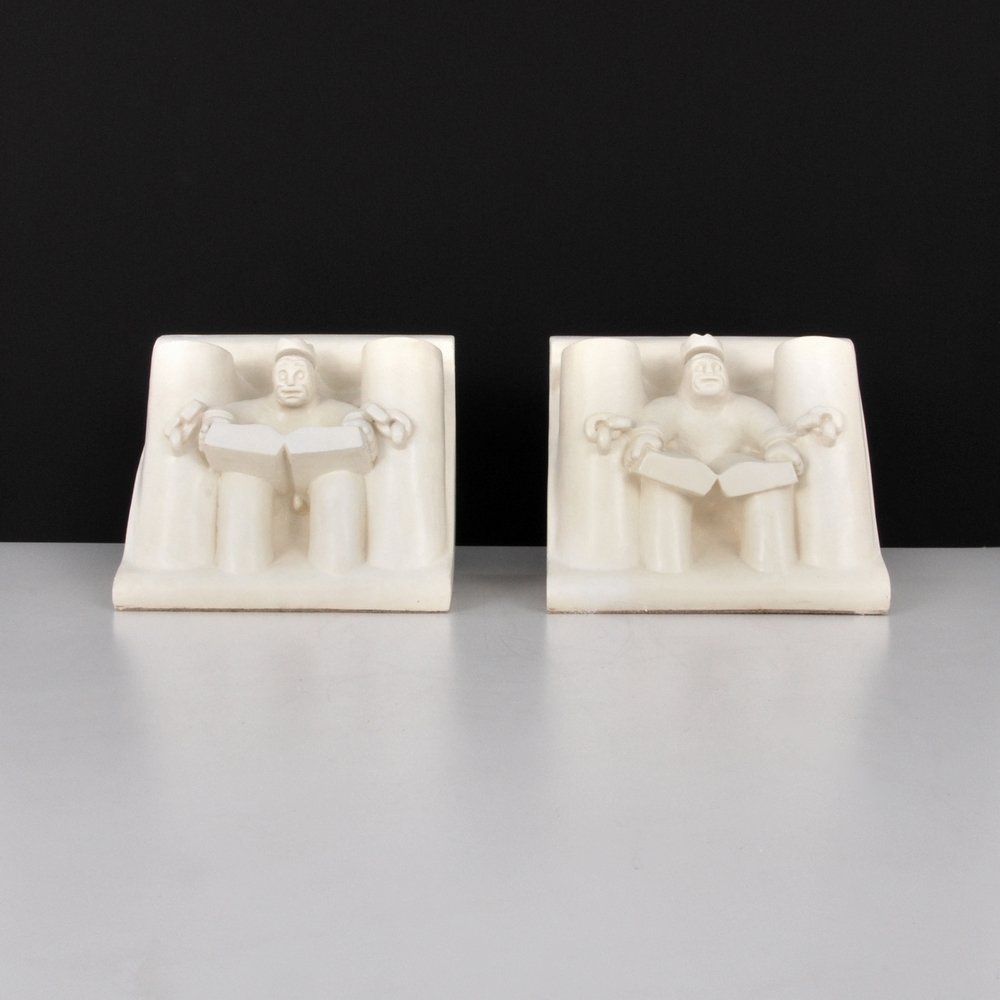 Tom Otterness Bookends: Designer (Artist) & Manufacturer: Tom Otterness (b. 1952) Markings: marked; 1984 Country of Origin & Materials: American; plaster Additional Information: Work titled "Kings Parade-König's Haus". Dime