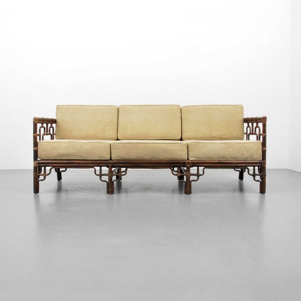 McGuire Rattan Sofa: Designer (Artist) & Manufacturer: McGuire Markings: marked Country of Origin & Materials: USA; wood, rawhide, upholstery Additional Information: (Key Word Search: McGuire, Dan Johnson, Brown Jordan, W