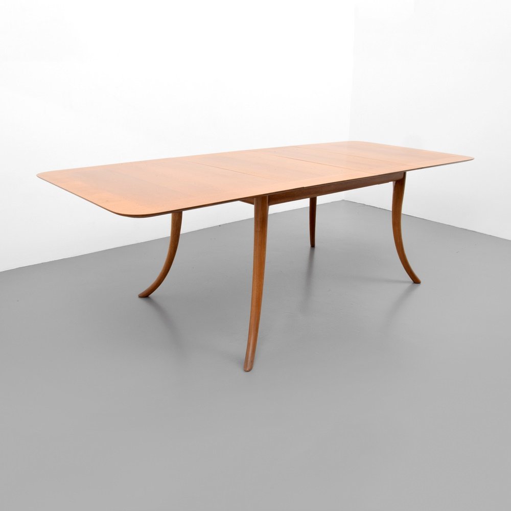 T.H. Robsjohn Gibbings Dining Table: Designer & Manufacturer: T.H. Robsjohn Gibbings; Widdicomb Markings: marking(s) Country of Origin & Materials: USA; wood Additional Information: Table is model #4309, has saber legs and two leaves. (K