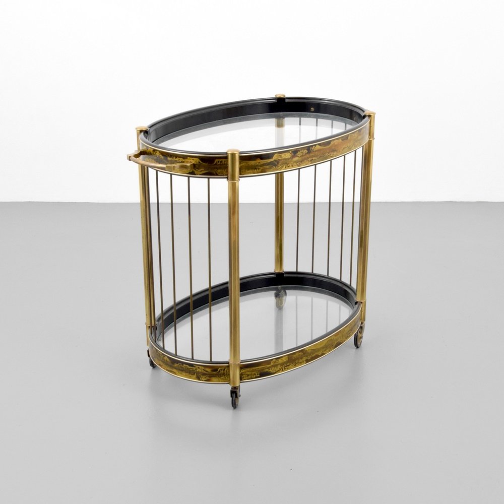 Bernhard Rohne Etched Two-Tier Tea Cart: Designer & Manufacturer: Bernhard Rohne; Mastercraft Markings: no marking(s) apparent Country of Origin & Materials: USA; brass, glass Additional Information: Wheeled tea cart has extensive etched des