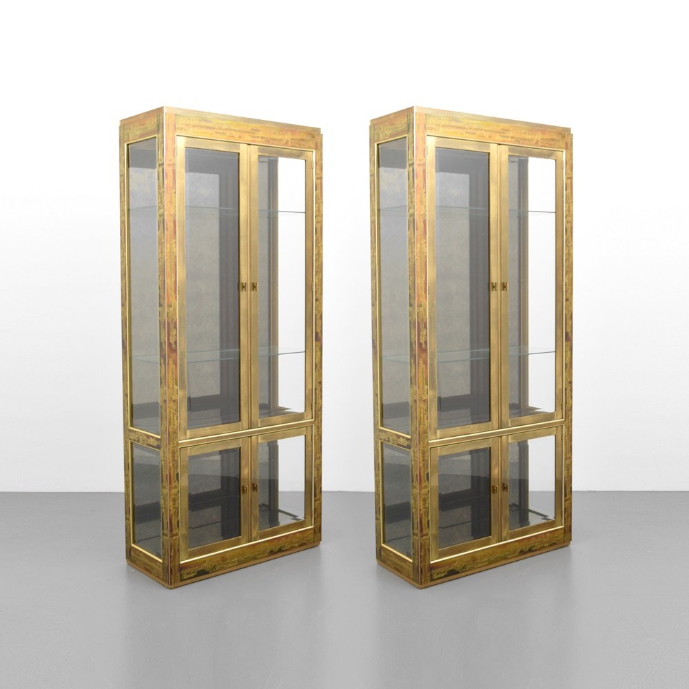Pair of Bernhard Rohne Etched Display Cabinets/Étagères: Designer & Manufacturer: Bernhard Rohne; Mastercraft Markings: no marking(s) apparent Country of Origin & Materials: USA; brass, glass Additional Information: Cabinets have lights, three shelves (