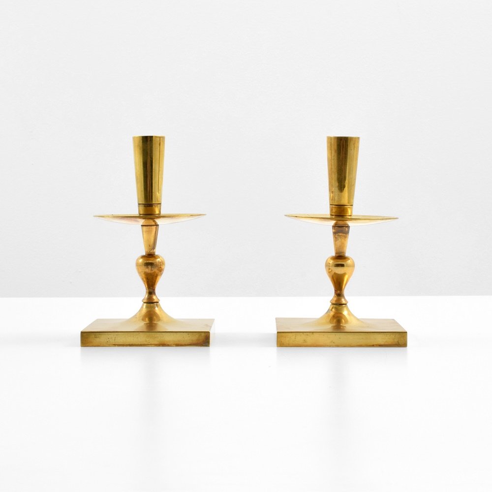 Pair of Tommi Parzinger Candlesticks: Designer & Manufacturer: Tommi Parzinger; Dorlyn Silversmiths Markings: marking(s) Country of Origin & Materials: USA; brass Additional Information: Provenance: collection of Carole A. Berk, Carole A.