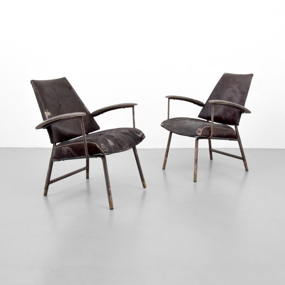 Pair of Jacques Adnet Lounge Chairs: Designer & Manufacturer :Jacques Adnet Markings: no marking(s) apparent Country of Origin & Materials: France; saddle-stitched leather, brass, hide Additional Information & Circa: Provenance: Atomic A