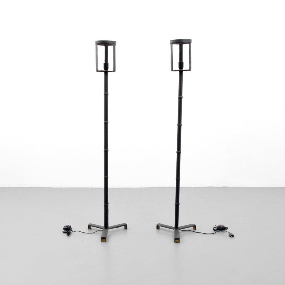 Pair of Jacques Adnet Floor Lamps: Designer & Manufacturer :Jacques Adnet Markings: no marking(s) apparent Country of Origin & Materials: France; metal, saddle-stitched leather Additional Information & Circa: Provenance: Atomic Antique