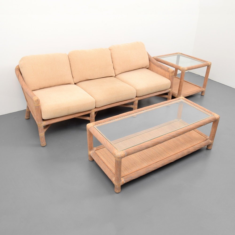 McGuire Sofa, Coffee Table & End Table: Designer & Manufacturer :The McGuire Furniture Co. Markings: The McGuire Furniture Co. label Country of Origin & Materials: USA; rattan, glass, upholstery, leather, woven caning Additional Information