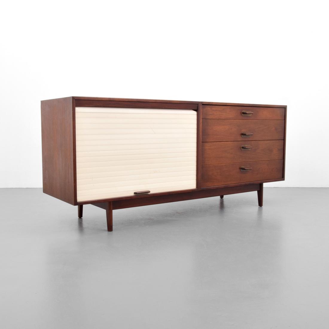 Jens Risom Cabinet: Designer & Manufacturer: Jens Risom; Jens Risom Design Markings: Jens Risom Design plaque Country of Origin & Materials: USA; wood, other Additional Information: Cabinet has four drawers and a tambour