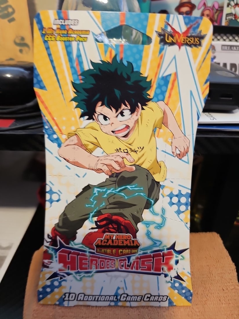My Hero Academia UniVersus Heroes Clash Booster Pack 10 Cards: Dive into the action-packed world of My Hero Academia with the Heroes Clash Card Pack, featuring 10 collectible cards from Jasco Games. Each pack contains a mix of powerful heroes like All Might,
