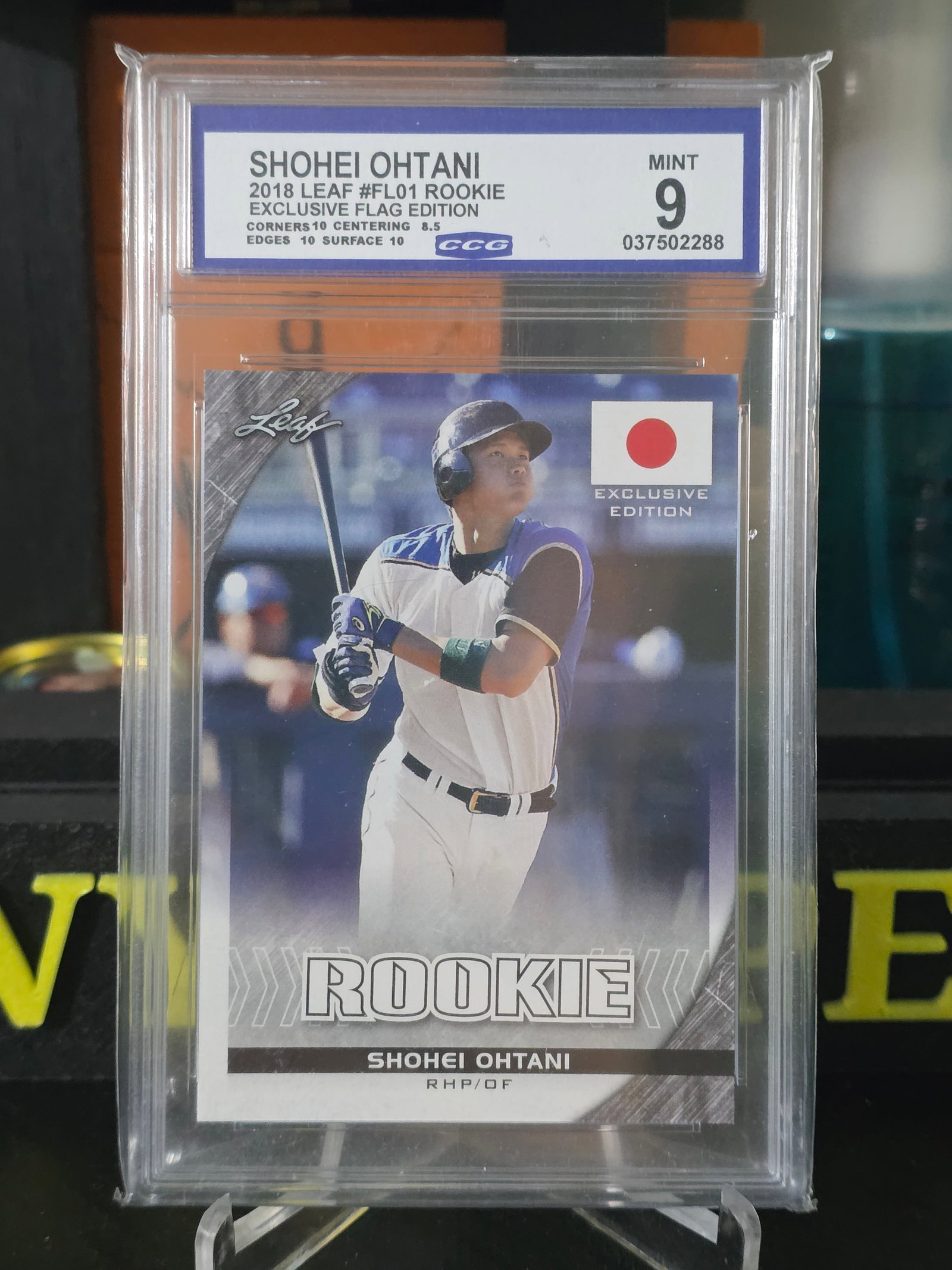 2018 Shohei Ohtani Leaf Rookie #FL01 Exclusive Flag Edition CCG 9 MINT: The product is a 2018 Shohei Ohtani Leaf Rookie #FL01 Exclusive Flag Edition CCG 9 Mint trading card. This card features an exclusive design with a standard card size and a 20 pt. thickness made of ca