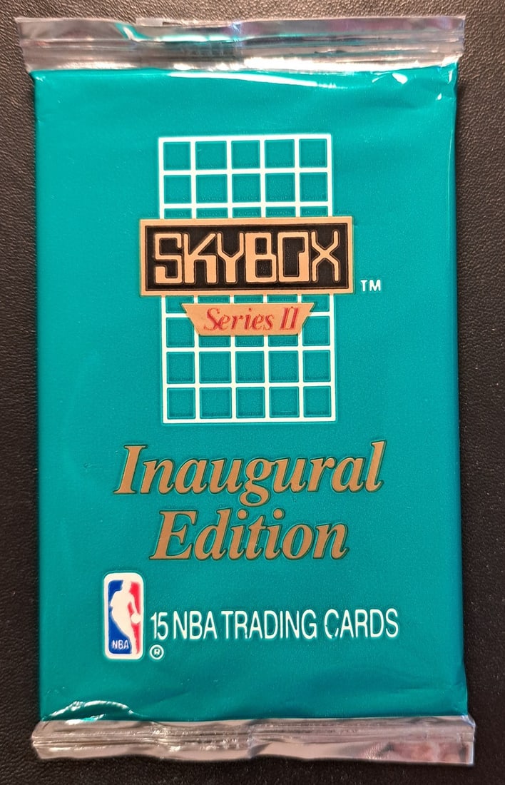 1990-91 SKYBOX NBA Basketball Cards Series 2 Inaugural Edition: The product is a 1990-91 NBA Skybox Series 2 basketball trading card pack, factory sealed and containing 15 standard-sized cards. This pack is from the National Basketball Association (NBA) and manufa
