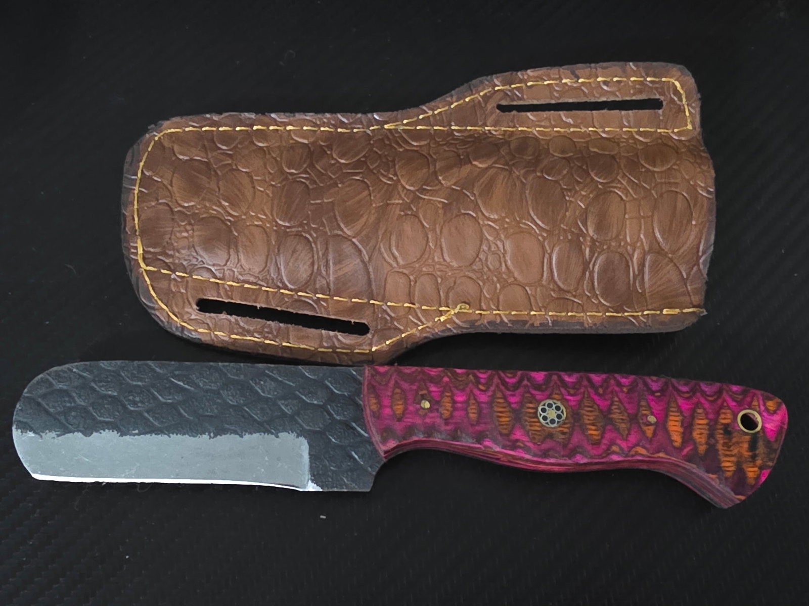 8.5in Hand-Crafted Fixed Blade “Bull Cutter” Knife w/ Wood Handle & Sheath: The 8.5-inch hand-crafted "Bull Cutter" knife is a high-quality fixed blade knife with a sheepsfoot blade made of carbon steel, featuring a silver color and full tang construction. The ambidextrous kn