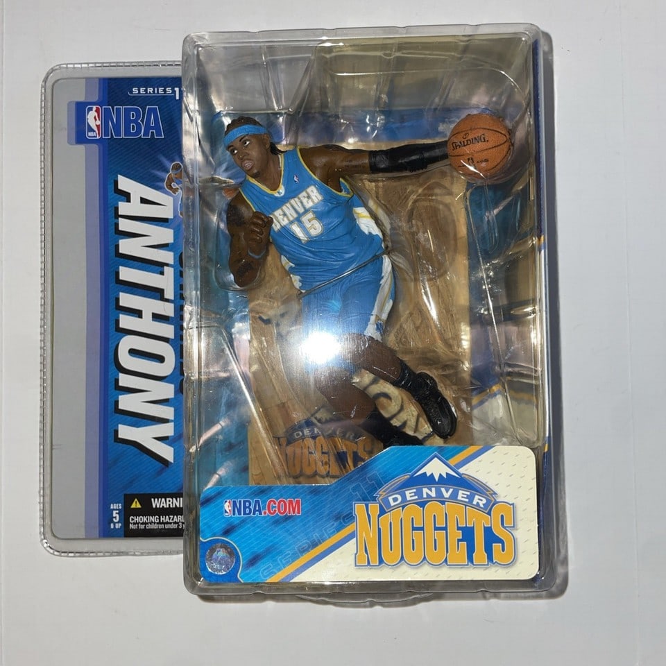Carmelo Anthony McFarlane Figure NBA Series 11 Denver Nuggets NIB Blue Jersey: The McFarlane NBA Series 11 Carmelo Anthony Denver Nuggets Action Figure is a 6-inch plastic figurine of the basketball player Carmelo Anthony in his Denver Nuggets uniform. Produced by McFarlane Toys