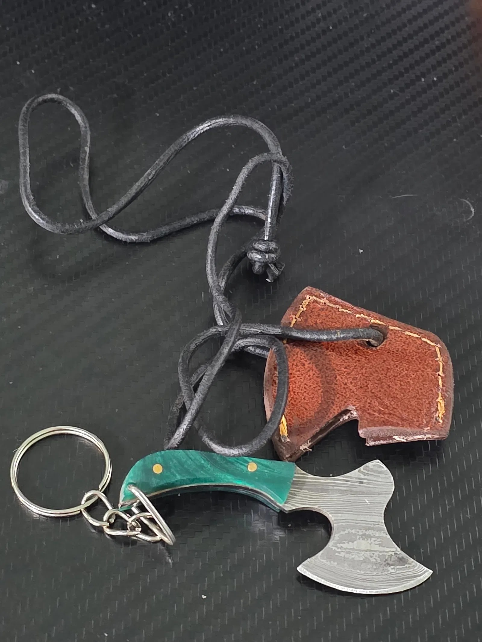 Mini Damascus Hatchet Axe Keychain with Sheath Wood Handle 3 1/2" Overall: Mini Damascus Hatchet Axe Keychain No Sheath Wood Handle 3 1/2" Overall green handle, sheath has vinyl cord for making it a necklace