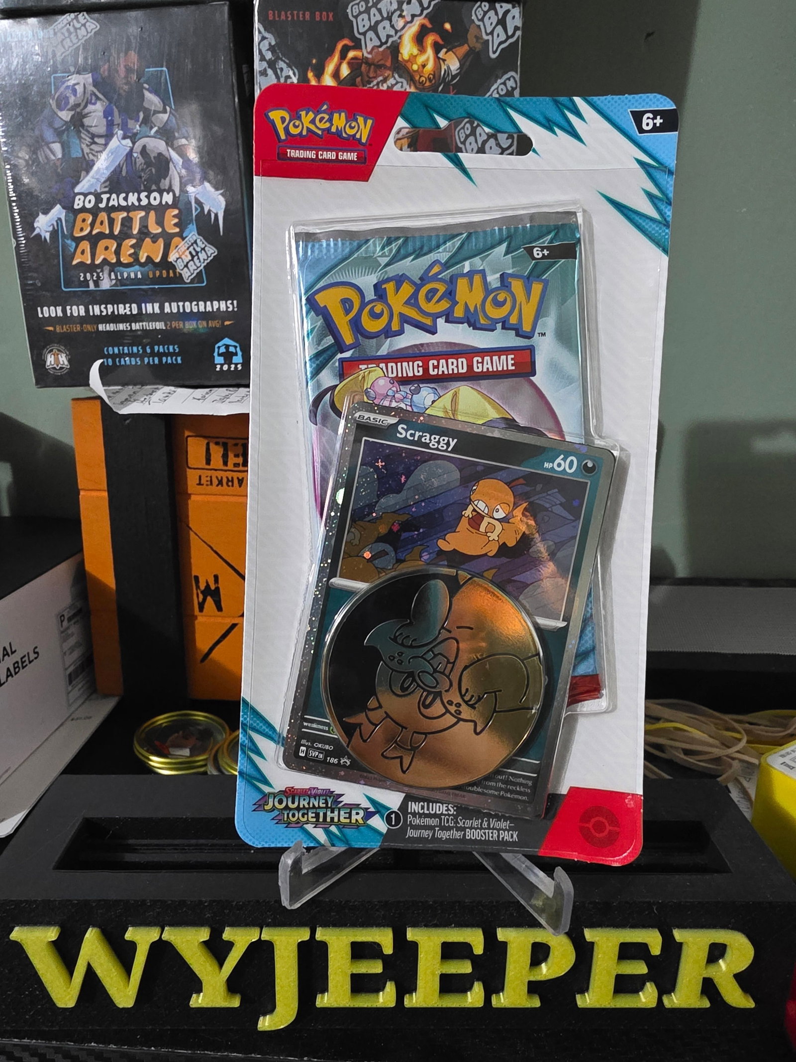 Single Booster Pack Blister - Sv09: Journey Together - Scraggy SVP185 Promo: The Pokemon Scarlet & Violet Journey Together 1-Booster Pack is a sealed collectible card game product featuring the character Scraggy. This pack includes 11 cards made of card stock and is part of th