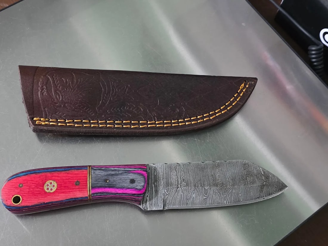 MHS Cutlery 8" Skinning Knife With Leather Sheath - Hand Made - Wood Handle: The MHS Cutlery Damascus Fixed Blade is a custom and handmade hunting knife with a drop point blade made of Damascus steel. It features a gray blade with a black wood handle, making it suitable for ev