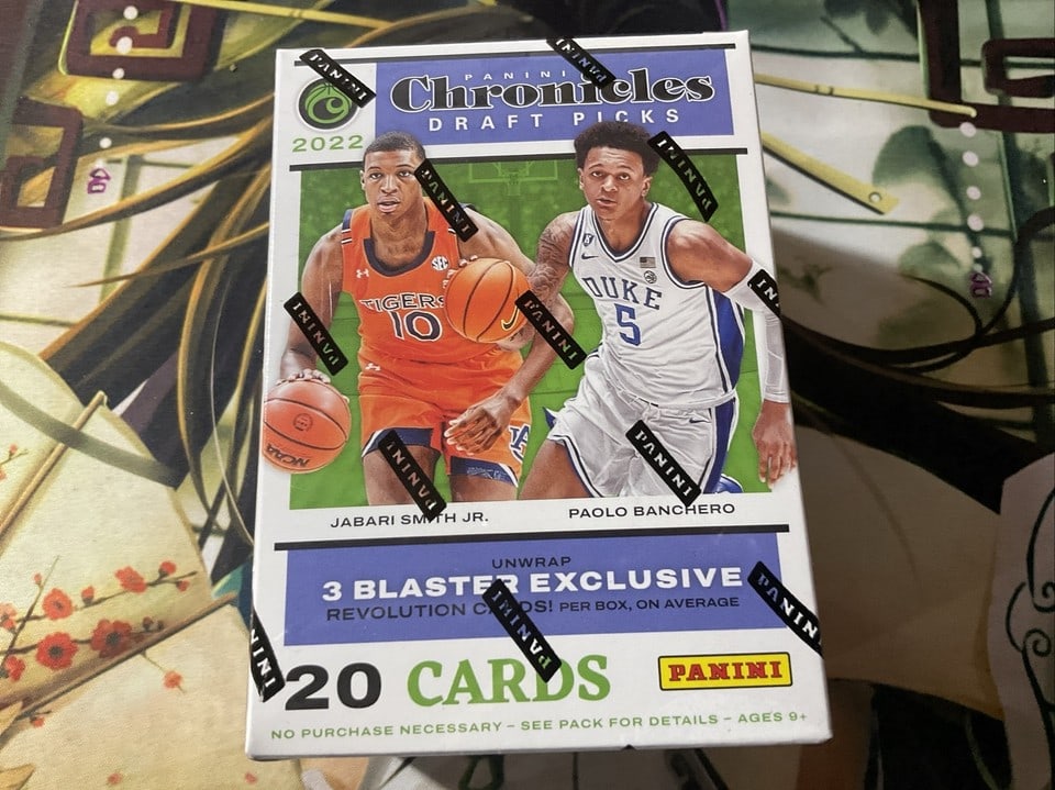 2022 Panini Chronicles Draft Picks Basketball Trading Card Blaster Box: The 2022 Panini Chronicles Draft Picks Collegiate Basketball Blaster Box is a sealed trading card box featuring basketball cards from the 2022 season. Manufactured by Panini, the box contains cards
