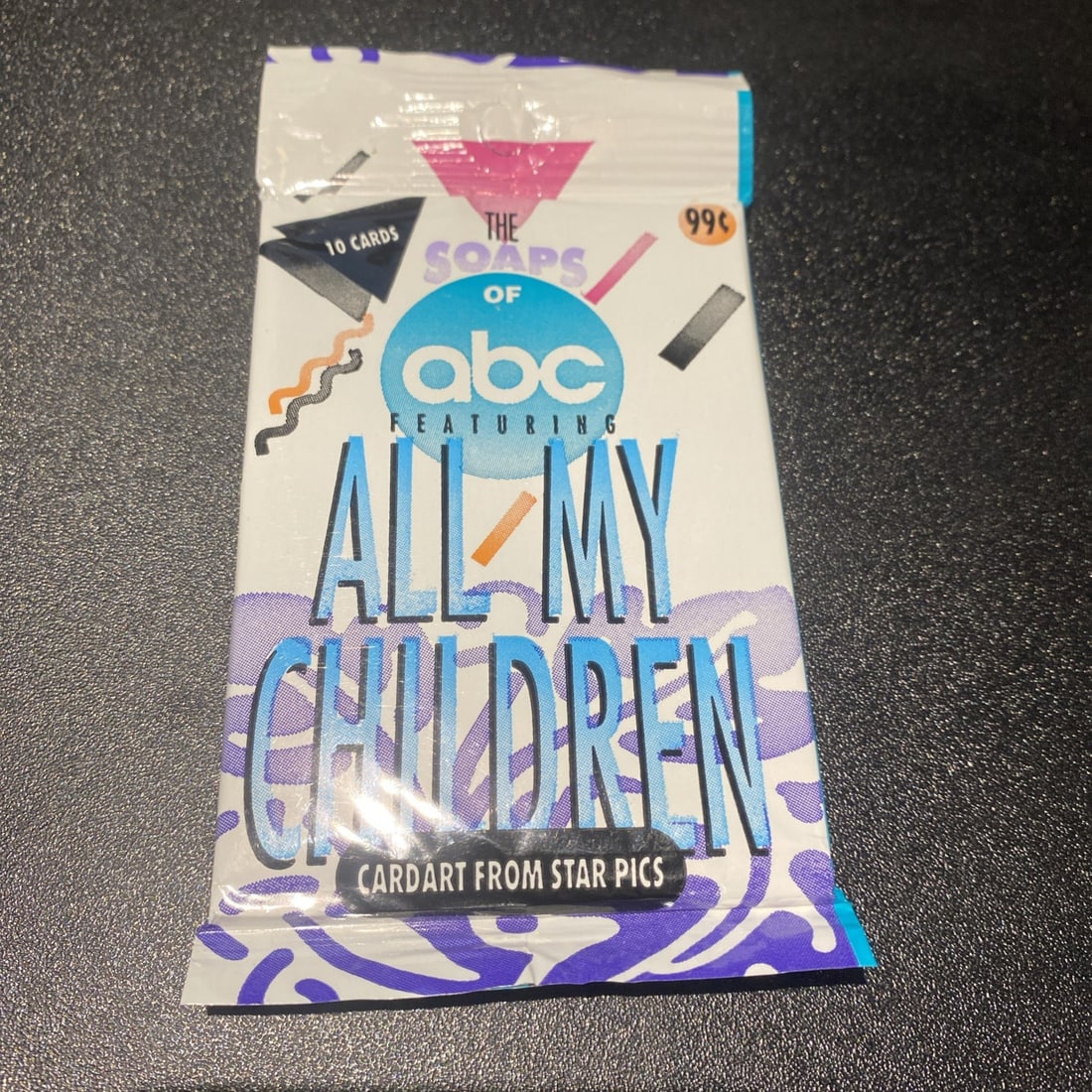 "All My Children" Sealed Trading Card Pack by Star Pics Inc. 1991.: The "All My Children" Sealed Trading Card Pack by Star Pics Inc. from 1991 offers collectors the chance to own cards featuring characters from the iconic soap opera. This pack includes 10 cards focusi