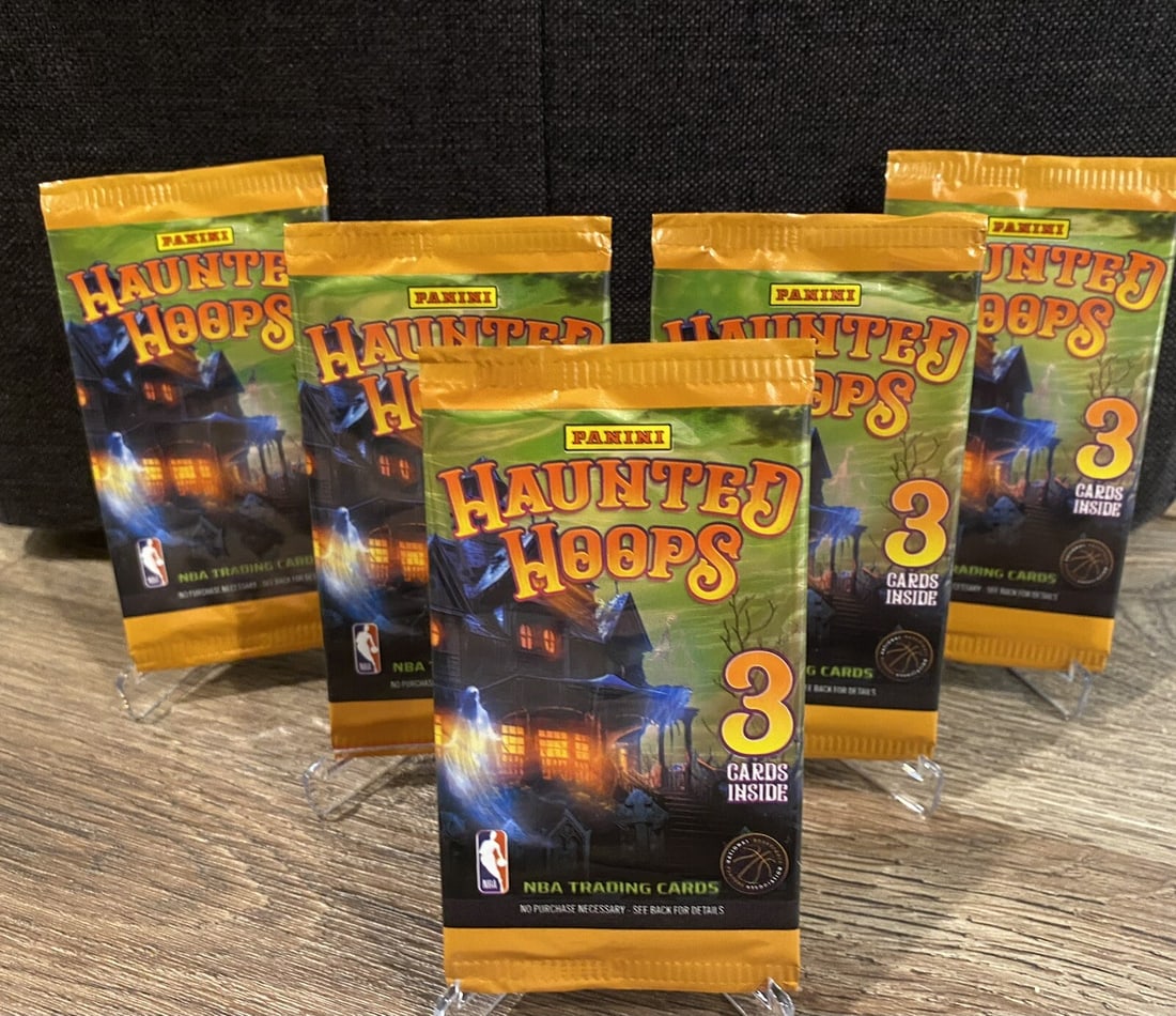 5 Packs of 2023/24 Panini Haunted Hoops Booster Packs: Get ready for some spooky fun with the 2023-24 Panini NBA Haunted Hoops sports trading card pack! These packs features three cards with chances to hit 4 different Wemby Rookies, who is sure to make a 