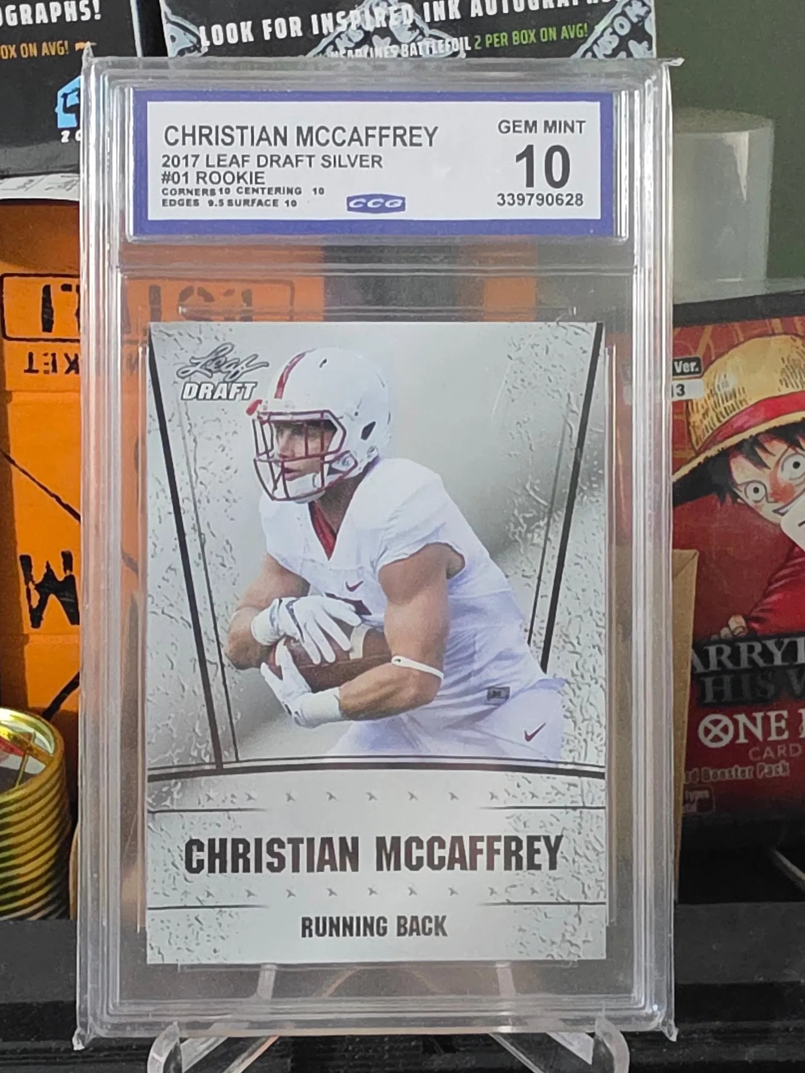 Christian McCaffrey 2017 Leaf Draft Rookie Silver CCG 10 GEM MINT: The product is a 2017 Leaf Draft Rookie Silver Christian McCaffrey trading card graded as CCG 10 GEM MINT. This card features the player in his San Francisco 49ers uniform and is an original licensed 