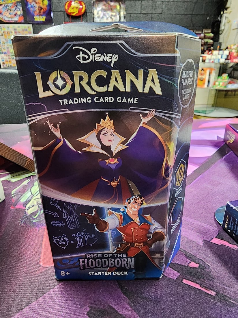 Disney Lorcana: Rise of the Floodborn Starter Deck - Amber and Sapphire: The Disney Lorcana starter deck includes everything you need to start playing against another player who has their own deck. Through these decks, you'll get a taste of the rich story and varied charac
