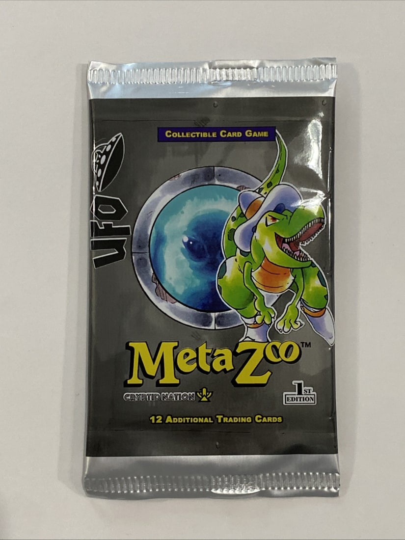 MetaZoo CCG Cryptid Nation UFO 1st First Edition Booster Pack TCG: The MetaZoo CCG Cryptid Nation UFO First Edition Booster Pack is a collectible card game product containing 12 standard-sized cards made of card stock. Manufactured by MetaZoo Games in 2022, this