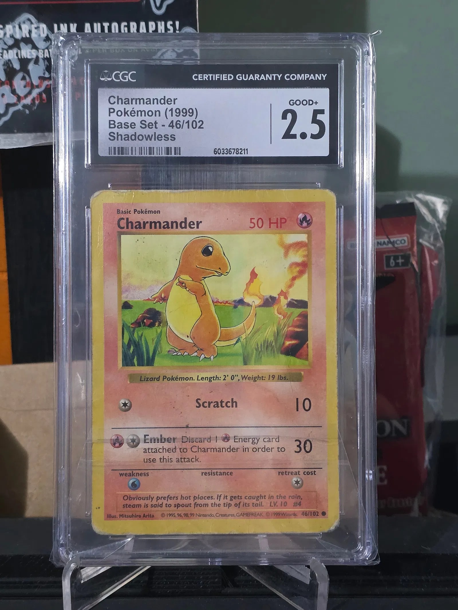 1999 Pokemon Charmander 46/102 1st Edition Shadowless CGC 2.5: The product is a 1999 Pokemon Charmander card from the Base Set, graded as a 2.5 Good by Certified Guaranty Company (CGC). It is a 1st Edition Shadowless card with a black dot designation, featuring