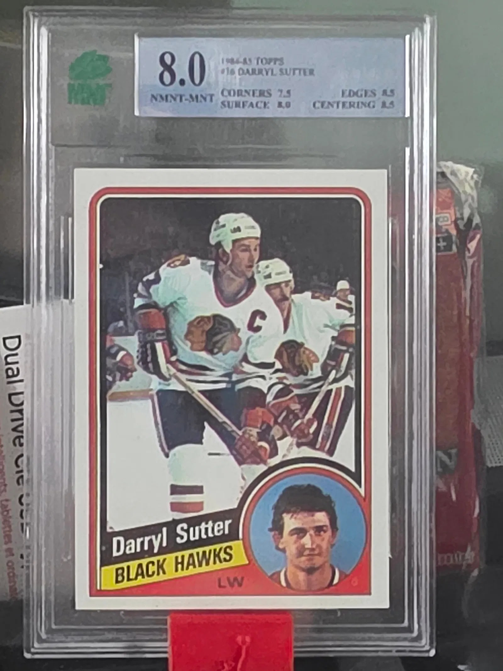 1984/85 O-PEE-CHEE NHL HOCKEY CARD #47 DARRYL SUTTER: Capture a piece of ice hockey history with the 1984-85 O-Pee-Chee #47 Darryl Sutter sports trading card. This card, graded MNT 8 NMNT/Mnt, represents a high-quality collectible from the notable