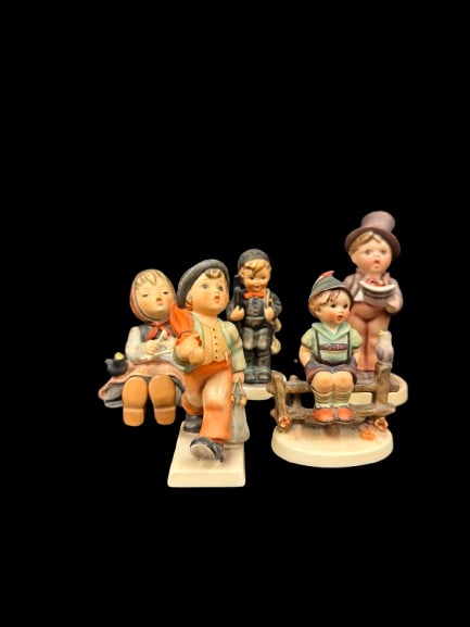 Set of 5 5-Inch Goebel Hummel Porcelain Figurines: A set of five Goebel Hummel porcelain figurines, each hand-painted with the signature warmth that has made Hummel a beloved collectible for generations. Goebel Hummels consistently attract strong
