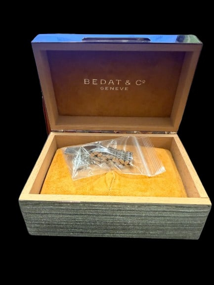 Bedat and Co Geneve Watch Box and Watch Band: A Bedat and Co. Geneve luxury watch box and watch band from the prestigious Swiss watchmaker. Bedat accessories appeal to watch enthusiasts and luxury goods collectors.