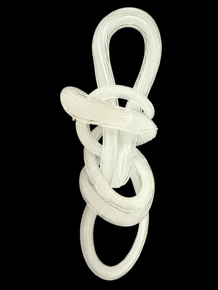 12 Inch Glass Knot Sculpture: A 12-inch glass knot sculpture weighing 3 pounds, a distinctive decorative art object with strong visual presence. Glass sculpture pieces of this scale make commanding centerpieces and conversation
