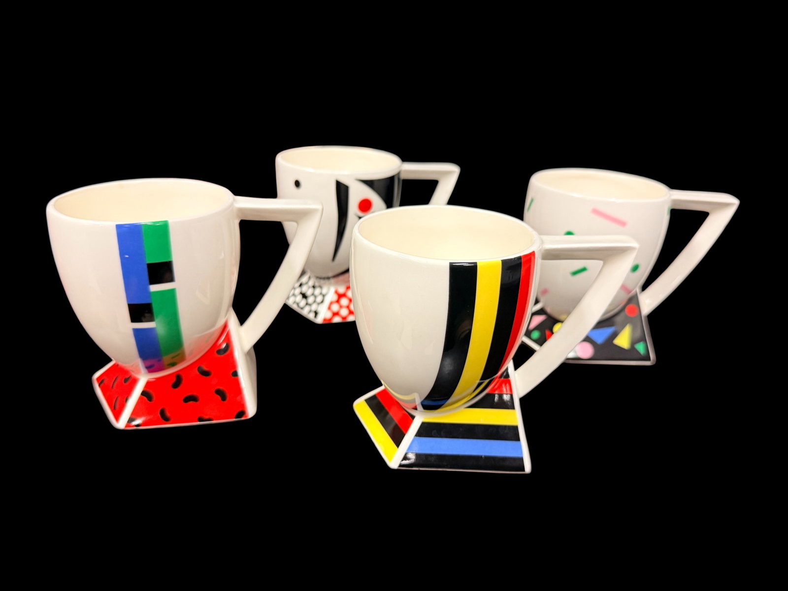Fujimori Collection Alpha-2 Series Mug Set of 4 from the 1980s: An iconic example of 1980s postmodern design, this set of four (4) mugs is from the highly collectible Alpha-2 Series by the Fujimori Collection. Manufactured in Japan by Kato Kogei, these pieces embo